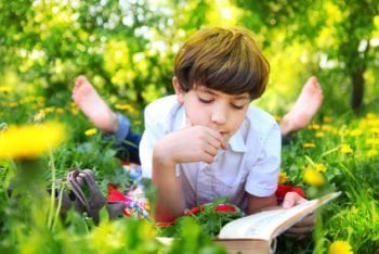 8-year-old-boy-reading-outdoors-e1471997119881
