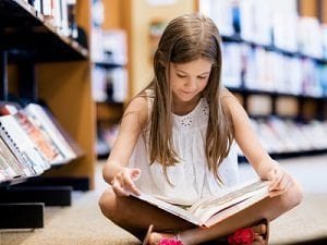 Girl-reading-book-in-library-300px