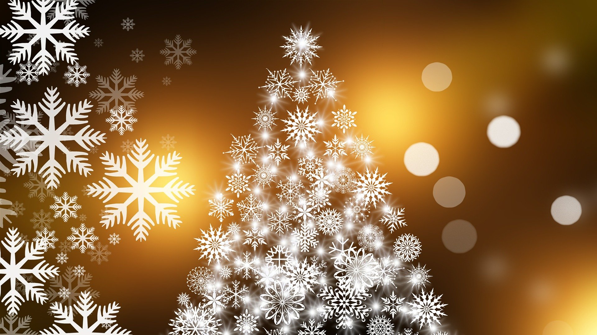 White Christmas tree made of snowflakes on a background with blurred yellow lights