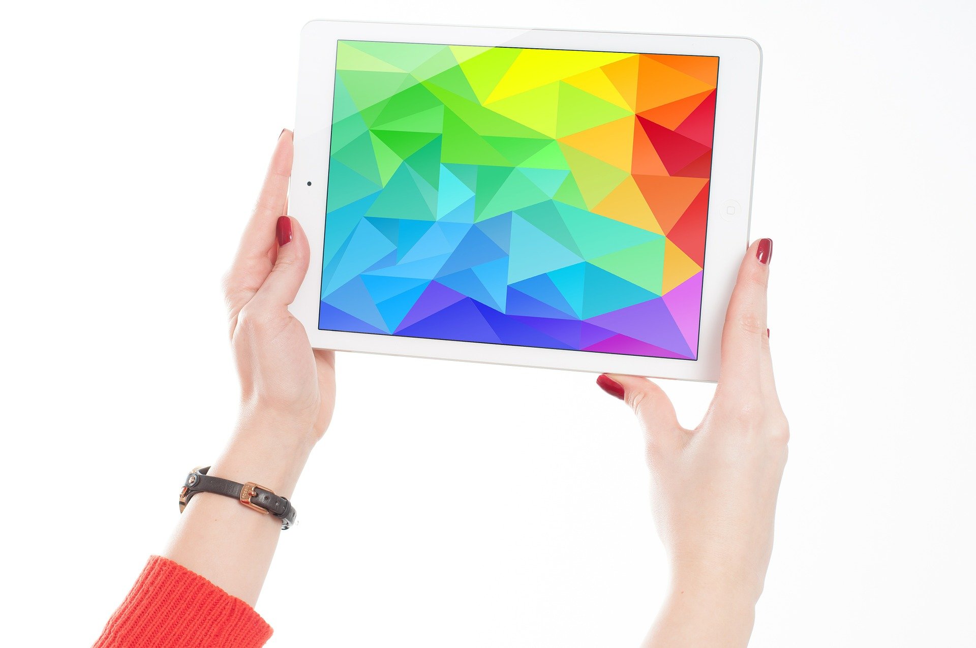 woman holding tablet showing abstract color pattern