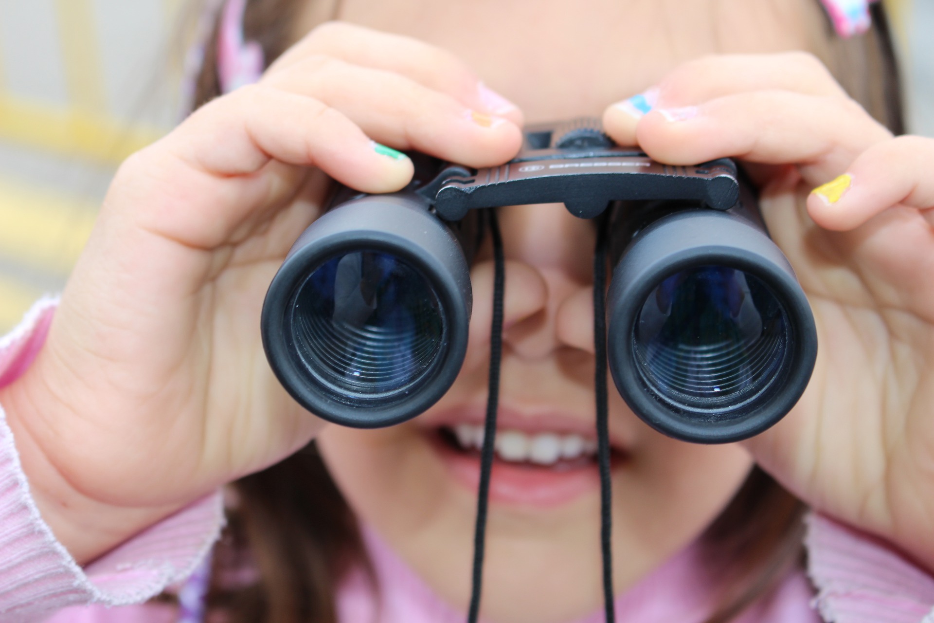 Girl looking through binoculars