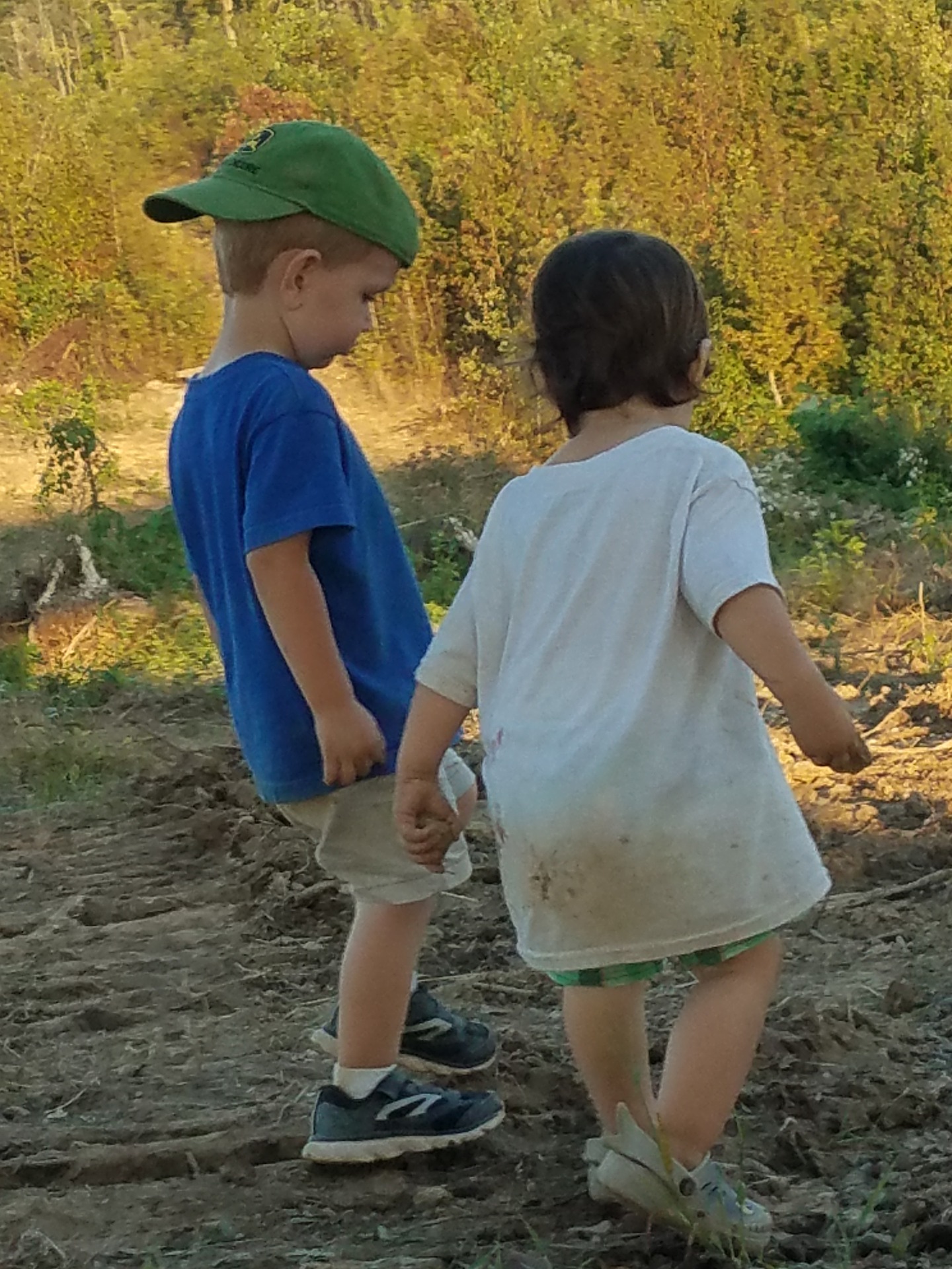 two boys walking on a path