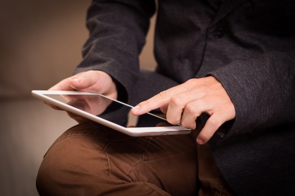 Teen boy playing with tablet