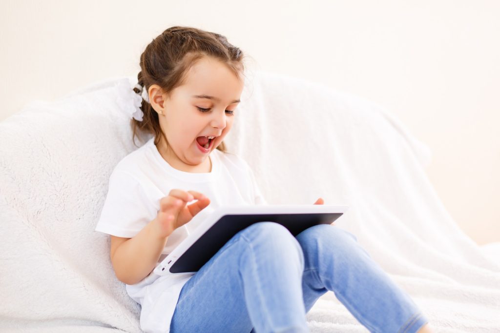 young girl playing with tablet