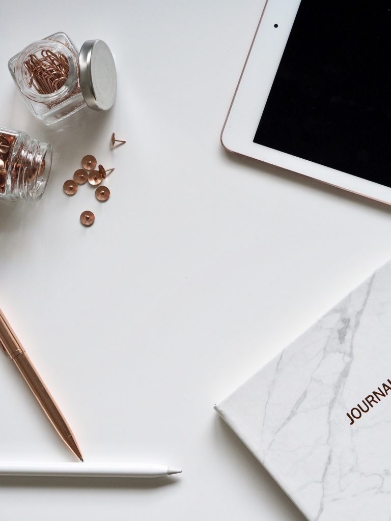 Journal and Apple tablet on the table