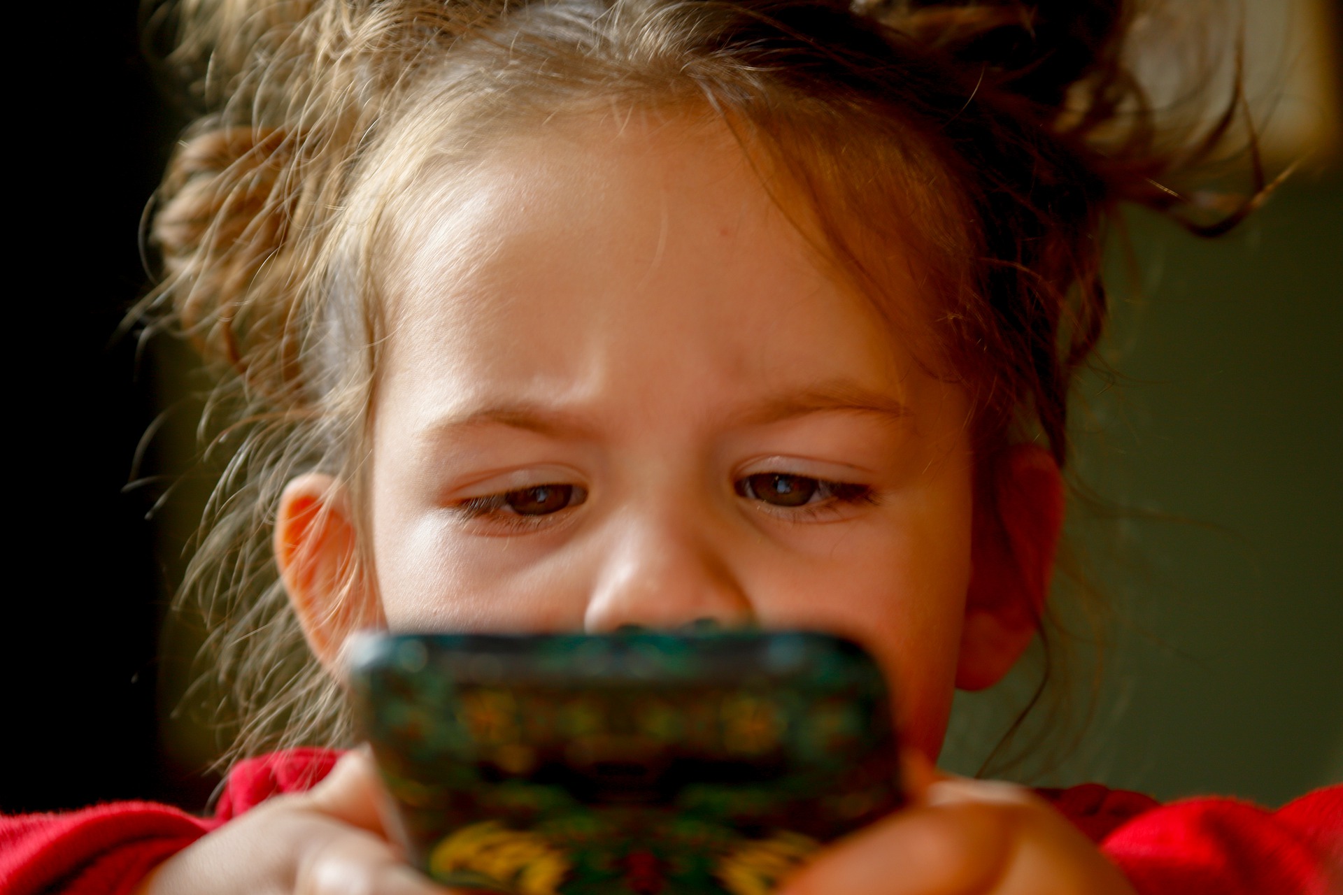 Young girl playing with phone
